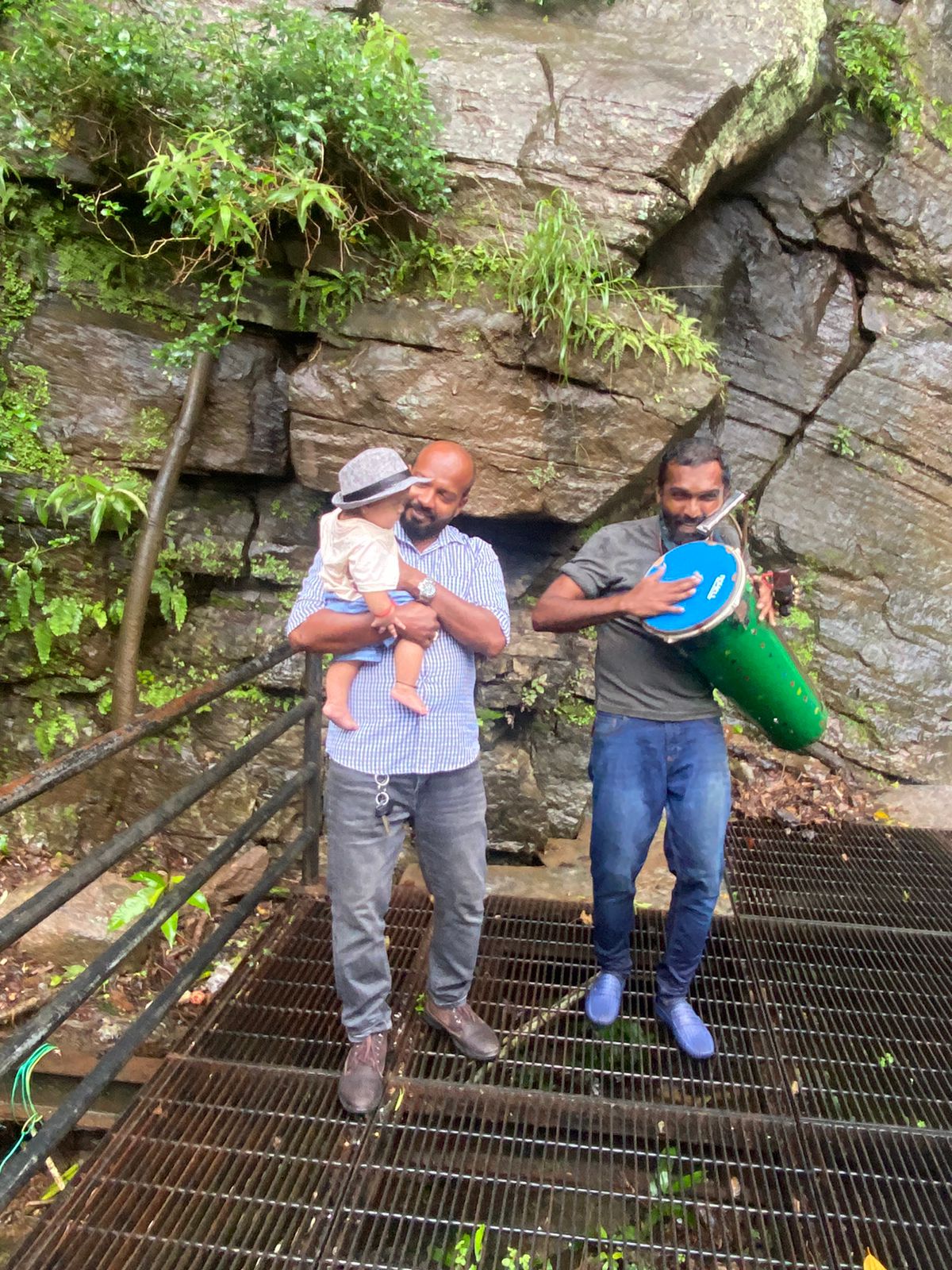 Two visitors on a forest stairway among rocks
